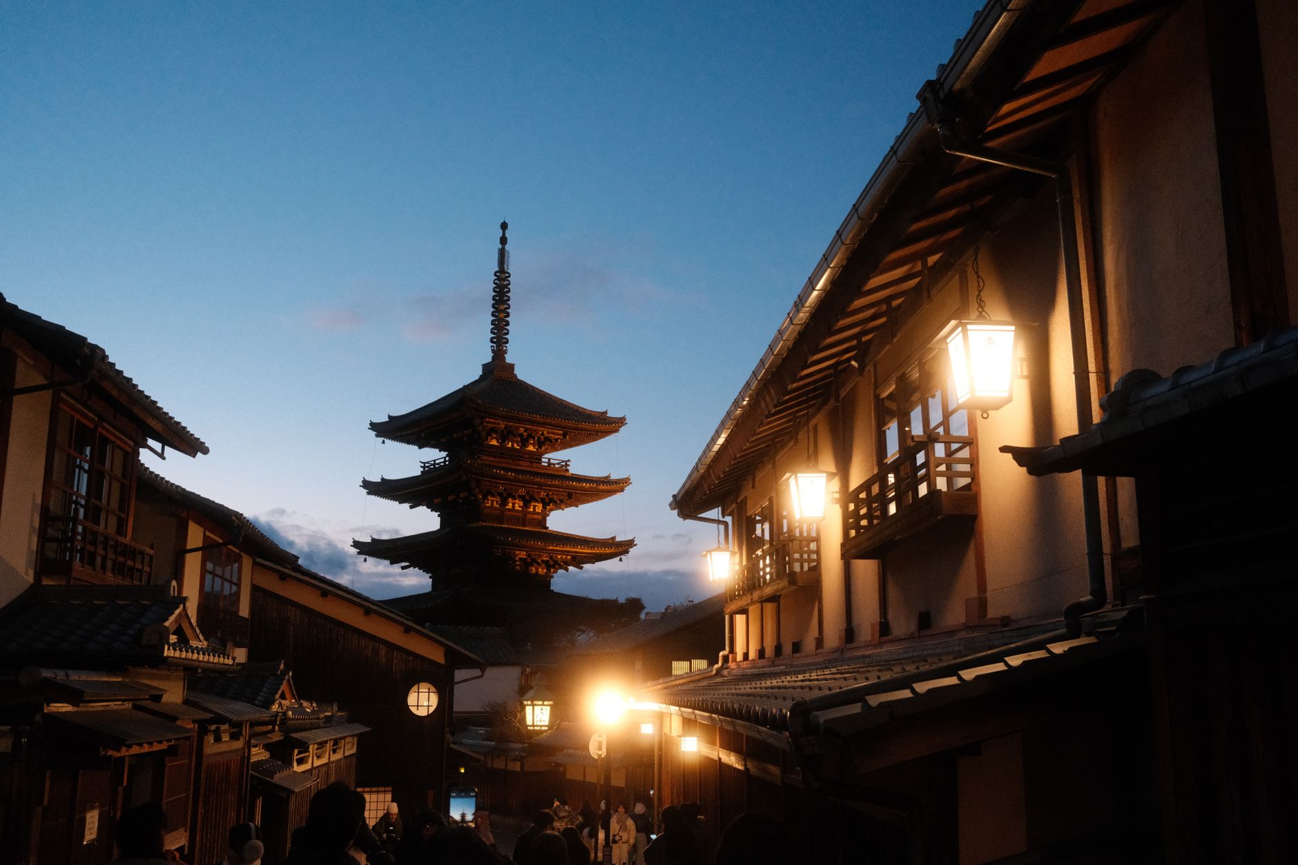 Lampiony a dřevěné tradiční domy v uličce Hanami-koji ve čtvrti Gion v Kjótu za soumraku