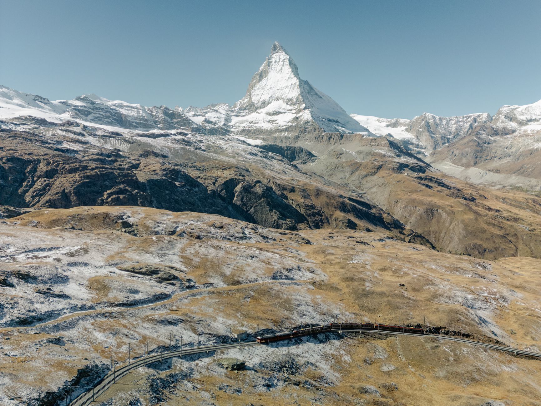 Ozubnicová horská železnice Gornergrat stoupající alpskou krajinou s panoramatem zasněžených štítů