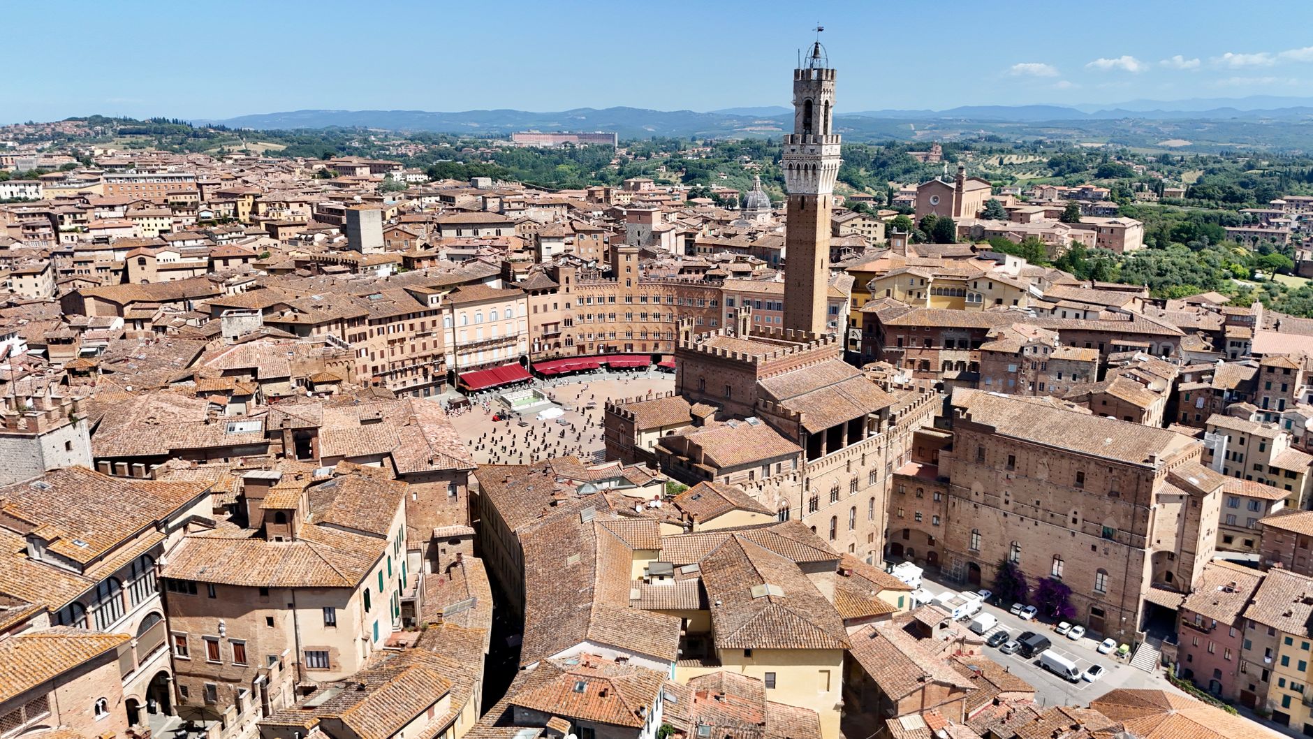 Panorama Sieny s katedrálou a věží Torre del Mangia nad střechami starého města v Toskánsku