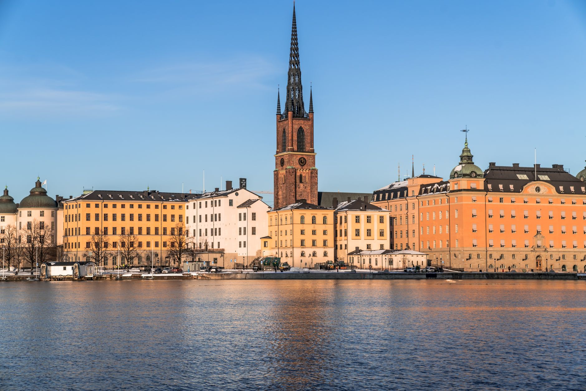 Barevné domy na nábřeží staré části Stockholmu Gamla stan se zrcadlí ve vodě