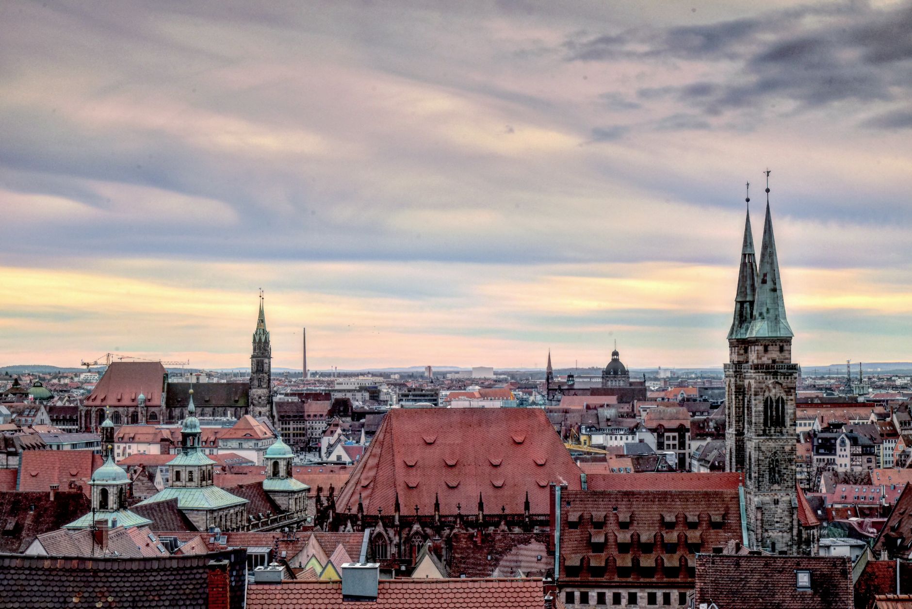 Panorama Lvova s věžemi kostelů a historickými střechami při západu slunce